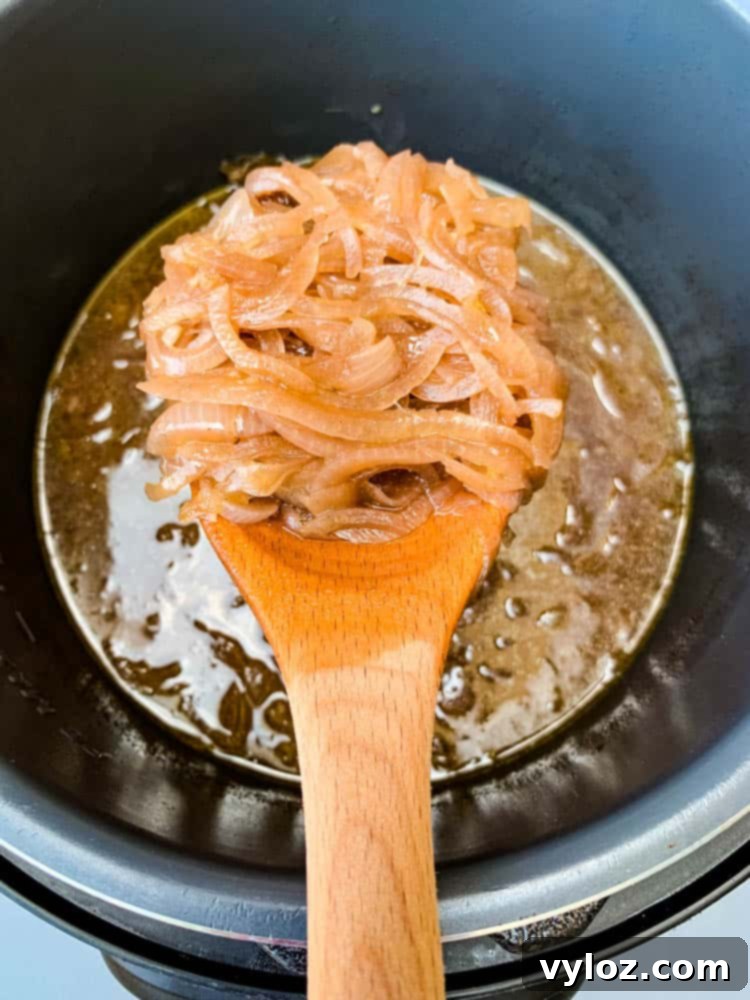 Effortless Instant Pot French Onion Soup 8 Instant Pot French Onion Soup with a wooden spoon