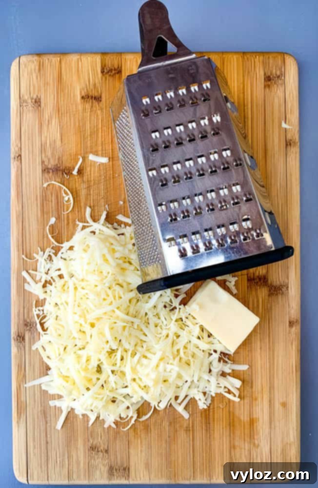 Effortless Instant Pot French Onion Soup 9 shredded cheese on a cutting board