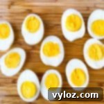 air fryer hard boiled eggs sliced on a bamboo cutting board