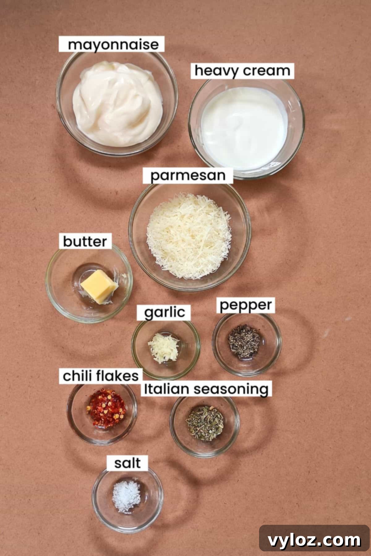 Copycat Buffalo Wild Wings Garlic Parmesan Sauce Recipe 3 Image showing buffalo wild wings garlic parmesan sauce recipe ingredients placed on an earthy background.