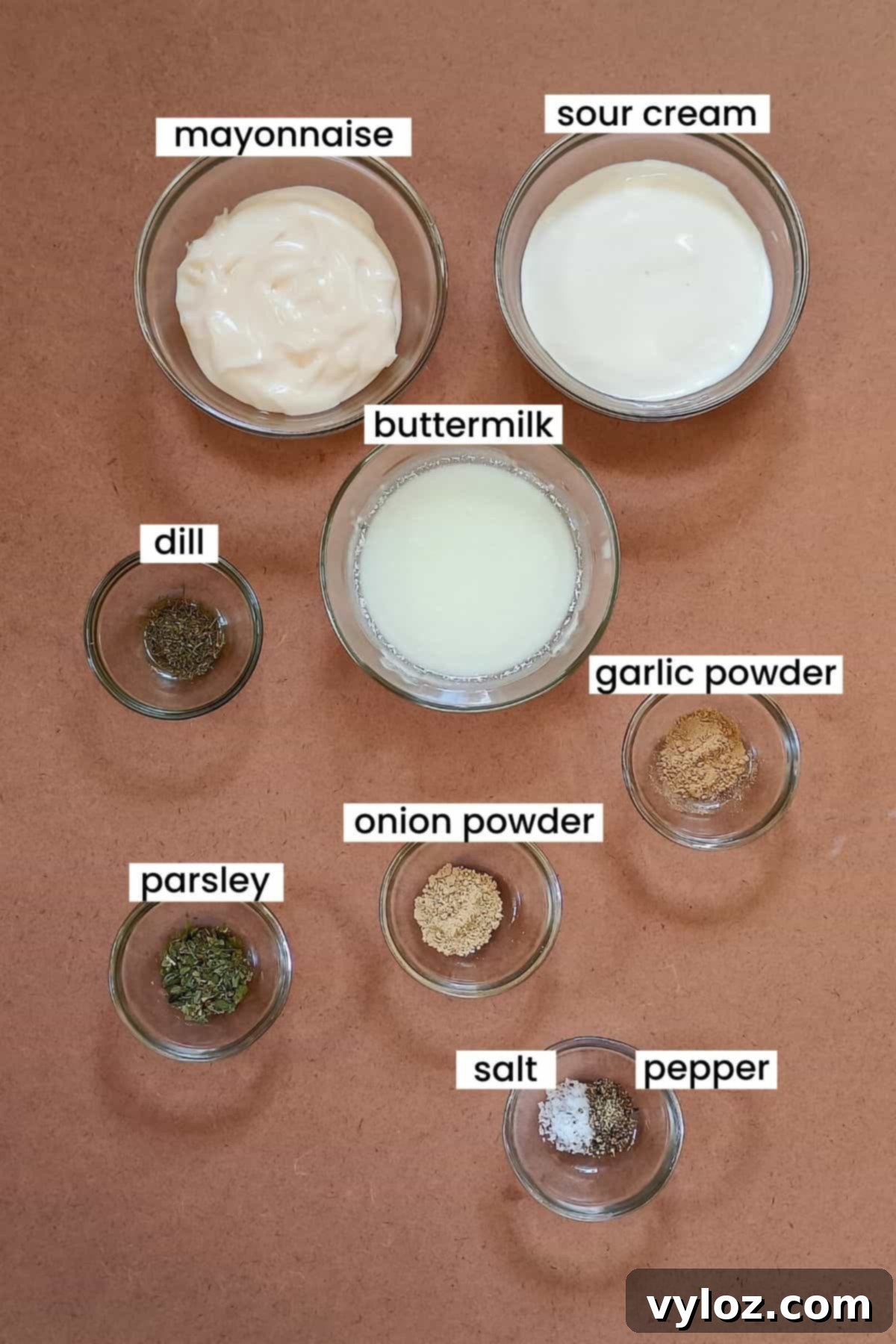 The Ultimate Homemade Wingstop Ranch 3 Image showing Wingstop ranch ingredients are placed on an earthy background, highlighting fresh herbs and creamy bases.