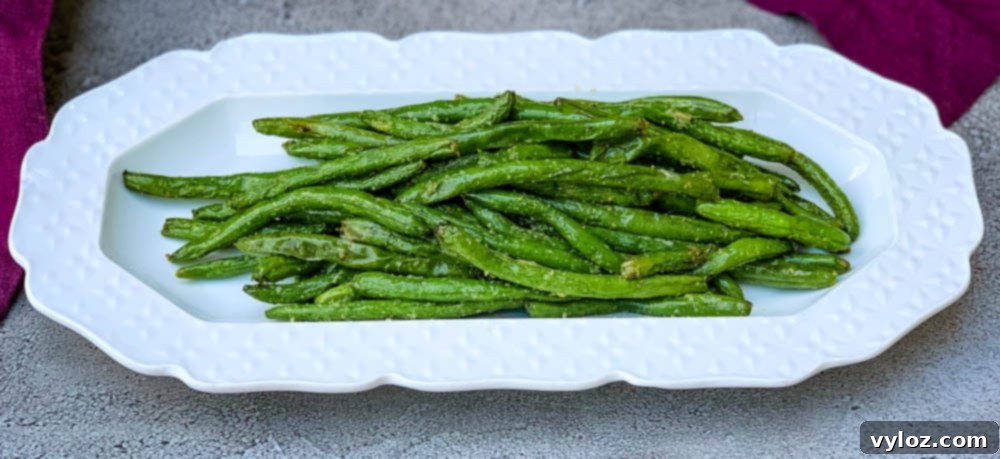 Crispy Air Fryer Garlic Green Beans 7 air fryer garlic green beans on a white plate