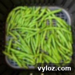 Crispy Air Fryer Garlic Green Beans 8 air fryer garlic green beans in an air fryer basket
