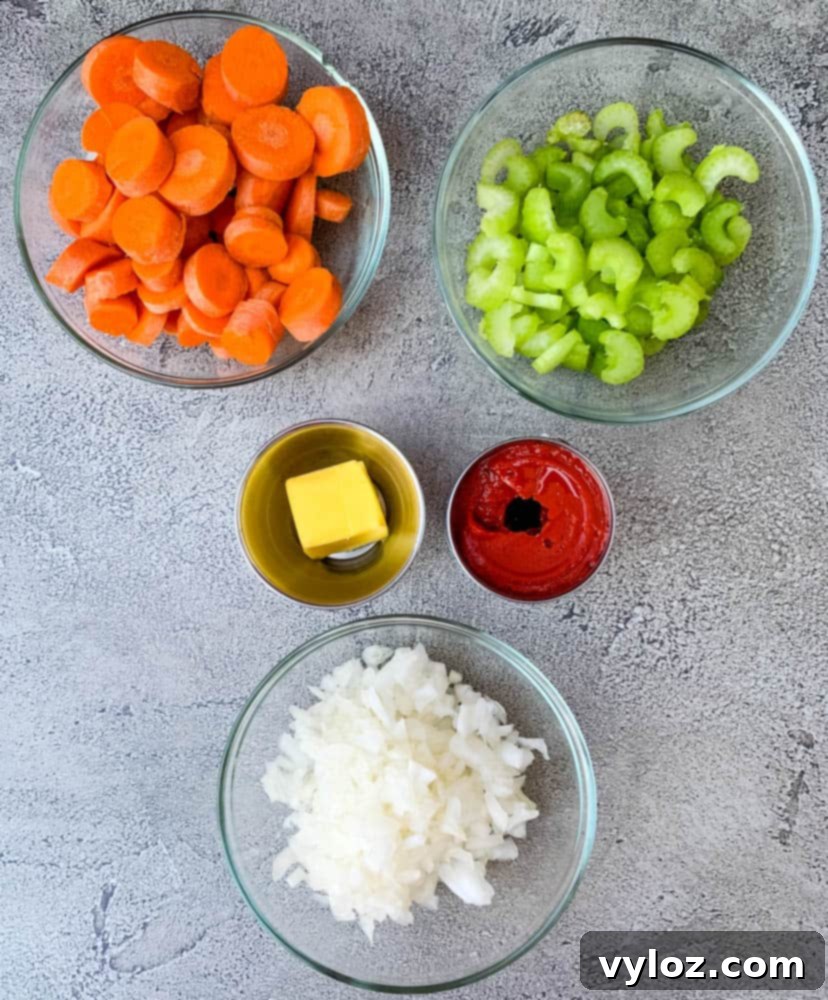 A captivating still life showing the essential components for creamy lobster bisque laid out: perfectly diced carrots, celery, and onions, alongside a rich red tomato paste and cubes of unsalted butter, all neatly arranged in individual bowls.