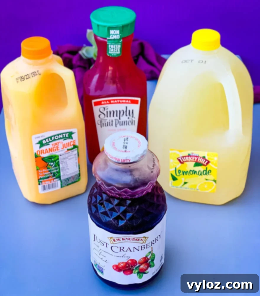 Bottles of orange juice, lemonade, cranberry juice, and fruit punch, key ingredients for Jungle Juice