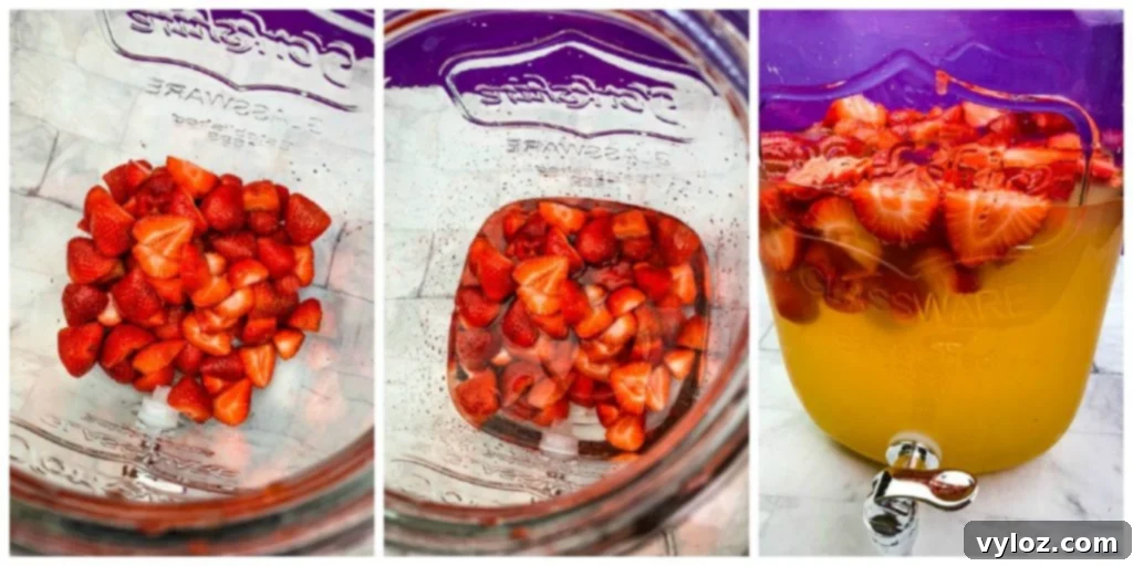Strawberries and alcohol soaking in a glass container, infusing flavor into the Jungle Juice