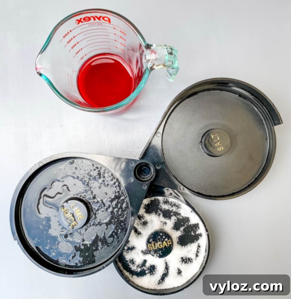 Crimson Mimosa 4 Close-up of a cocktail rimmer with sugar and lime juice, ready for garnishing a mimosa glass