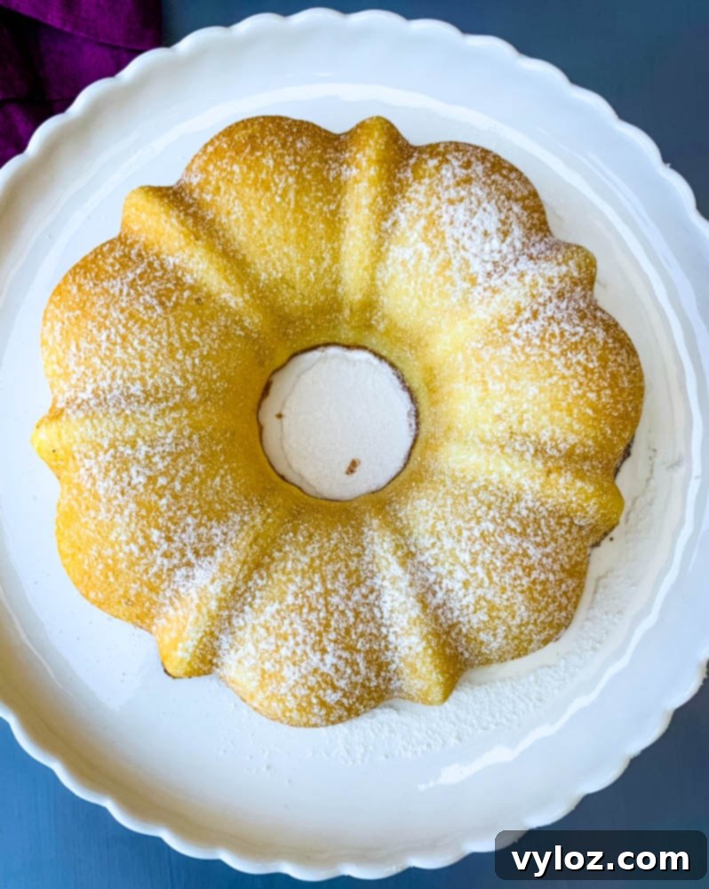 air fryer lemon cake on a white cake stand