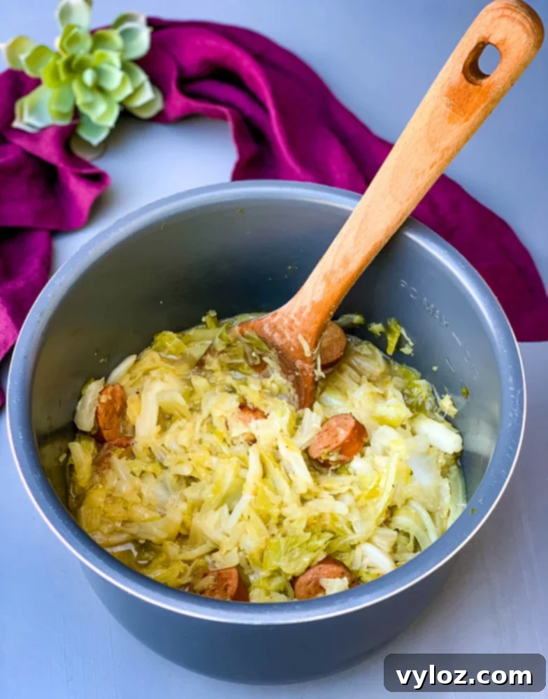 Instant Pot Cabbage and Sausage cooking in a pressure cooker