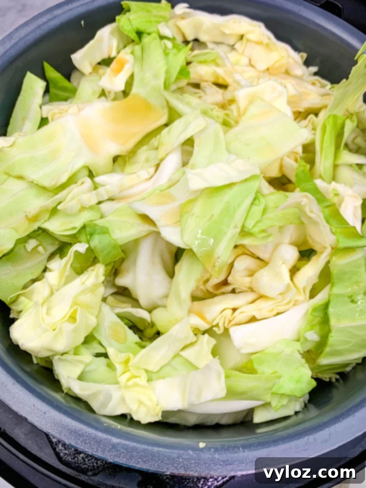 Instant Pot Cabbage and Sausage simmering inside an Instant Pot