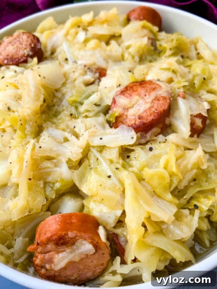 Instant Pot Cabbage and Sausage served in a rustic white bowl, ready to eat