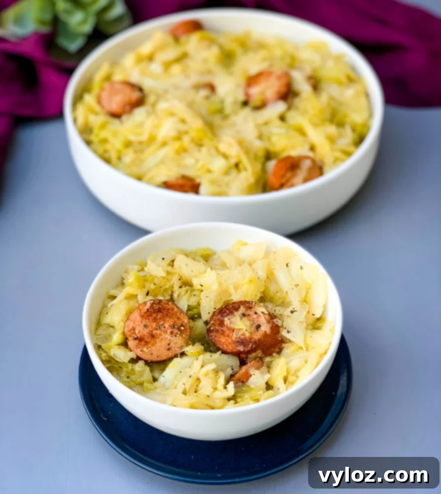 Instant Pot Cabbage and Sausage in a white bowl, ready for serving