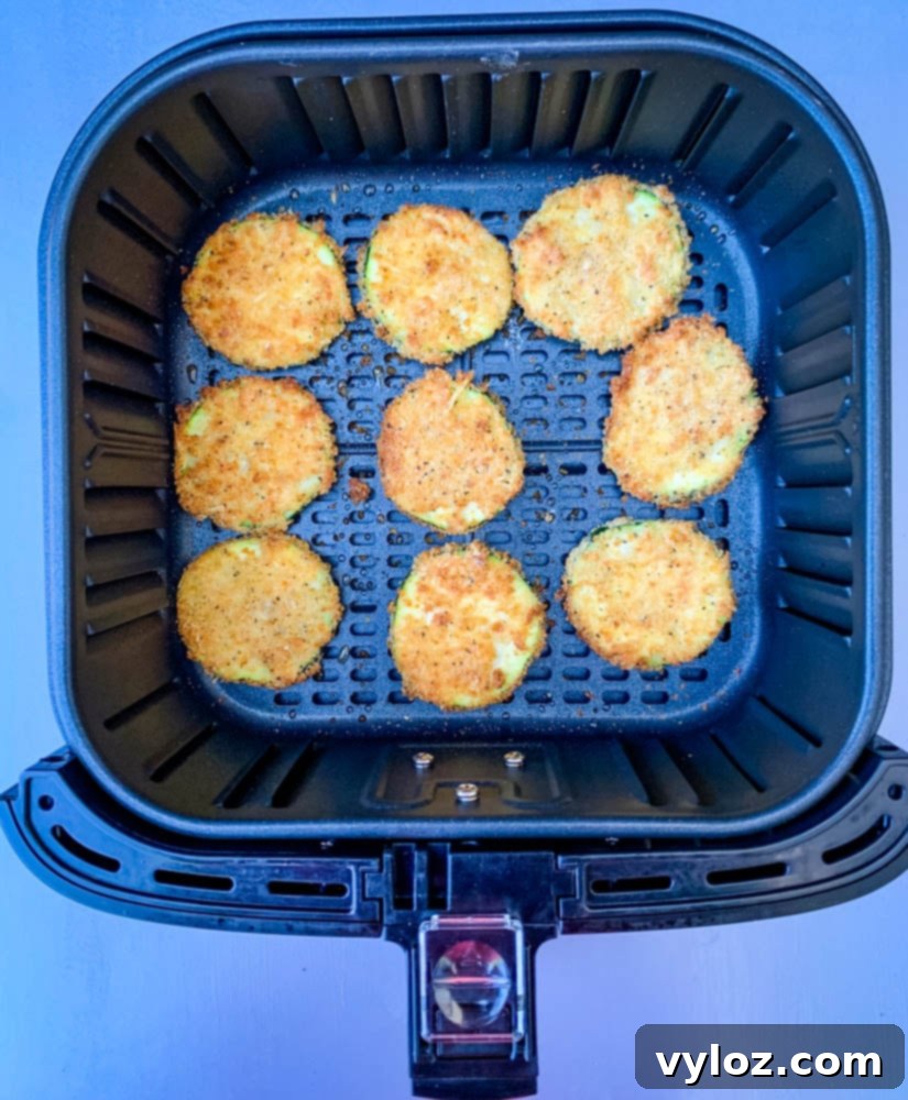 cooked zucchini chips in an air fryer