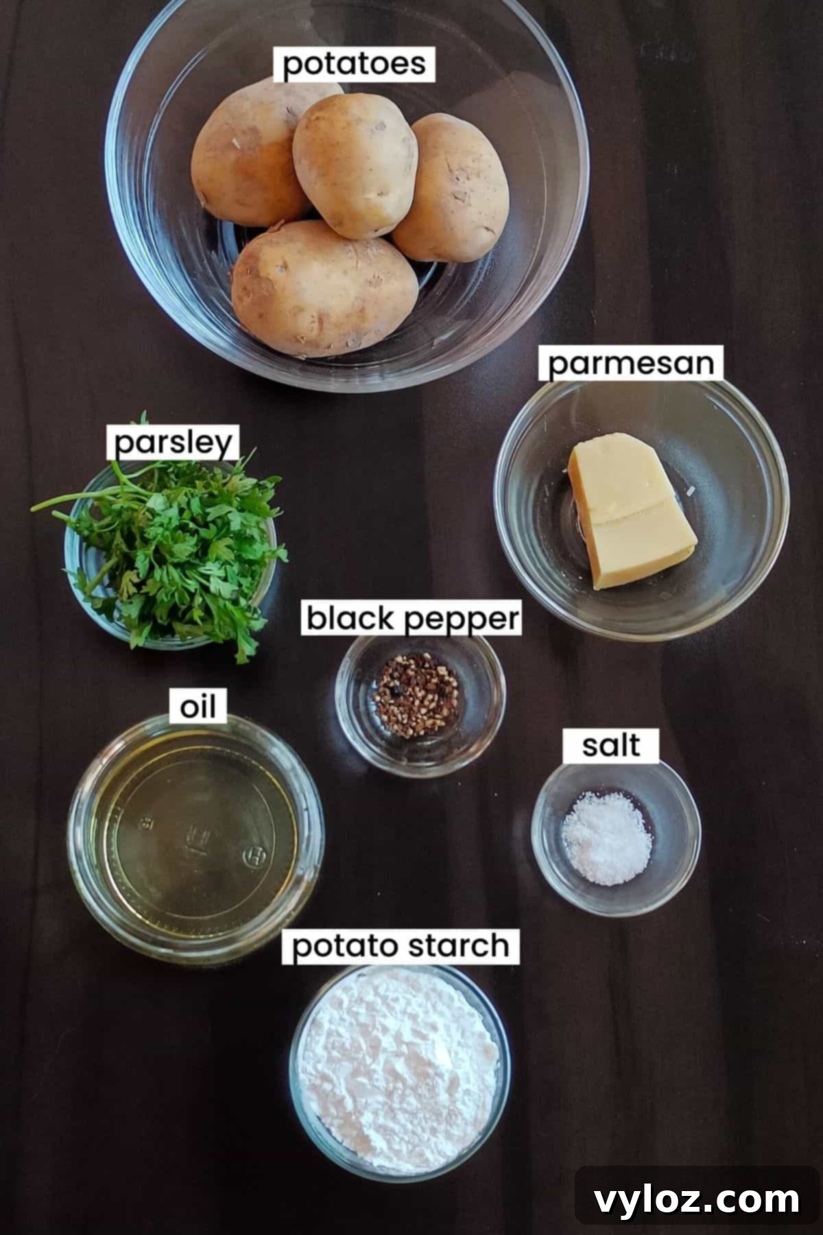 A vibrant flat lay image showcasing all the fresh ingredients needed to make crispy mashed potato fries, arranged neatly on a rustic brown wooden backdrop.