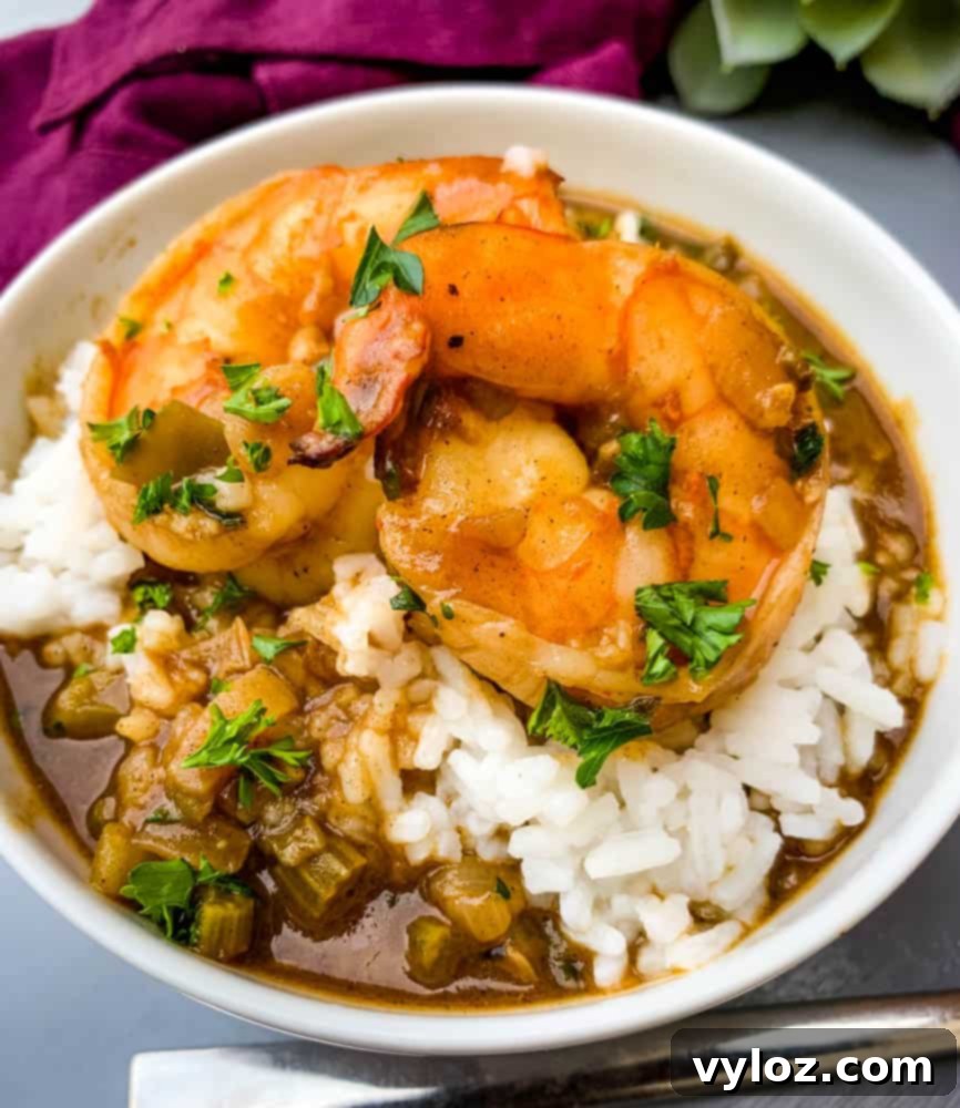 Cajun Shrimp Etouffee: Authentic Recipe 2 shrimp etouffee with white rice in a white bowl