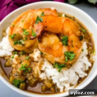 Cajun Shrimp Etouffee: Authentic Recipe 12 shrimp etouffee with white rice in a white bowl
