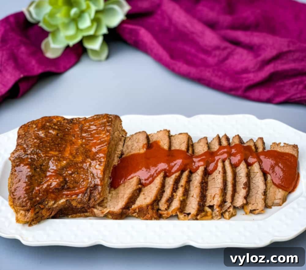 Tender Instant Pot Brisket 2 Instant Pot Beef Brisket with BBQ Sauce on a white plate
