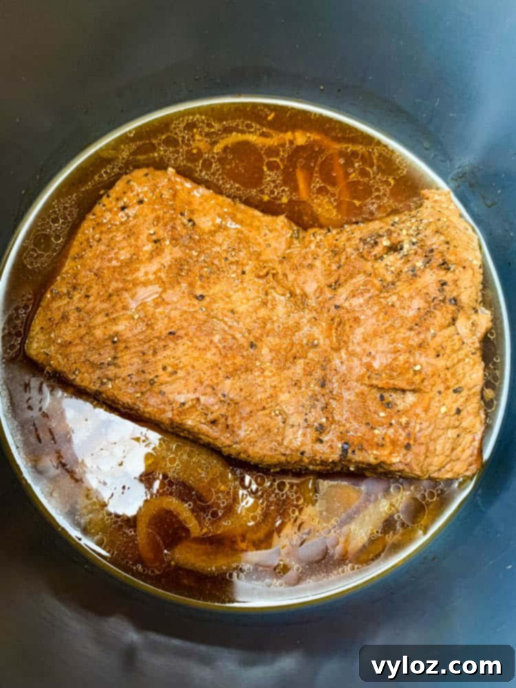 Tender Instant Pot Brisket 5 Instant Pot Brisket in a pressure cooker with broth