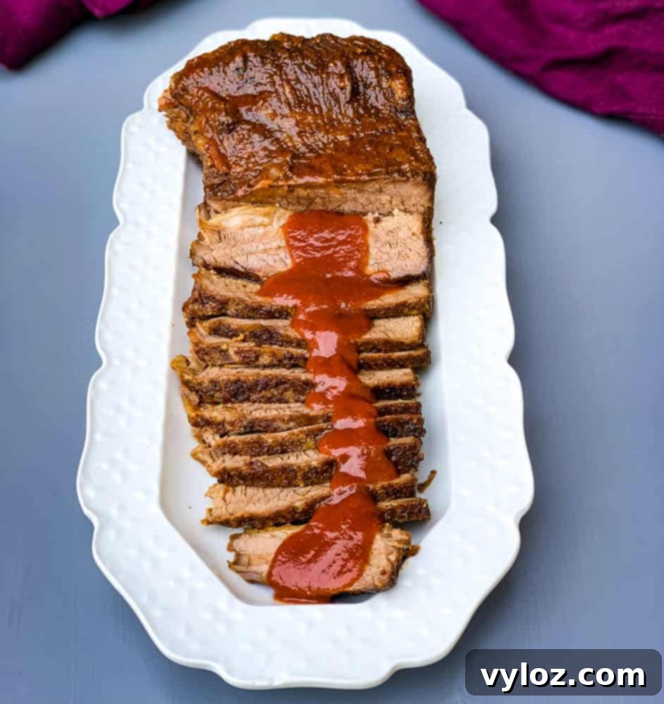 Tender Instant Pot Brisket 8 Instant Pot Beef Brisket with BBQ Sauce on a white plate