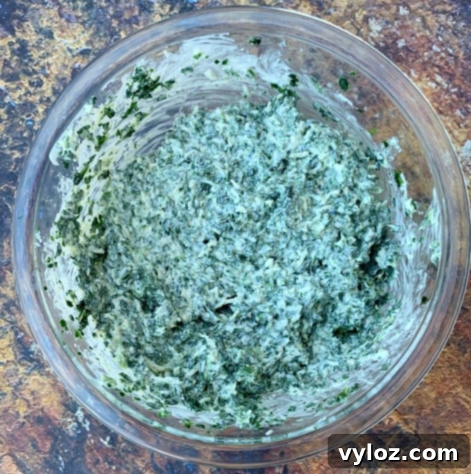 Warm Baked Spinach and Cheese Dip 4 Close-up of keto low carb spinach dip in a glass bowl, showcasing its creamy texture