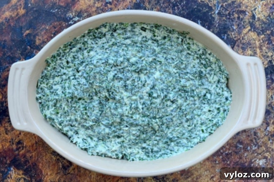 Warm Baked Spinach and Cheese Dip 6 Creamy keto low carb spinach dip ready to be baked in a ceramic bowl