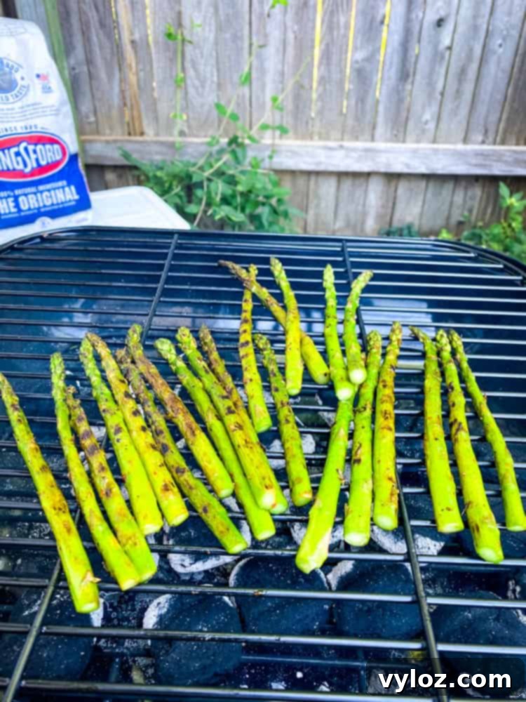 asparagus grilling on a charcoal grill