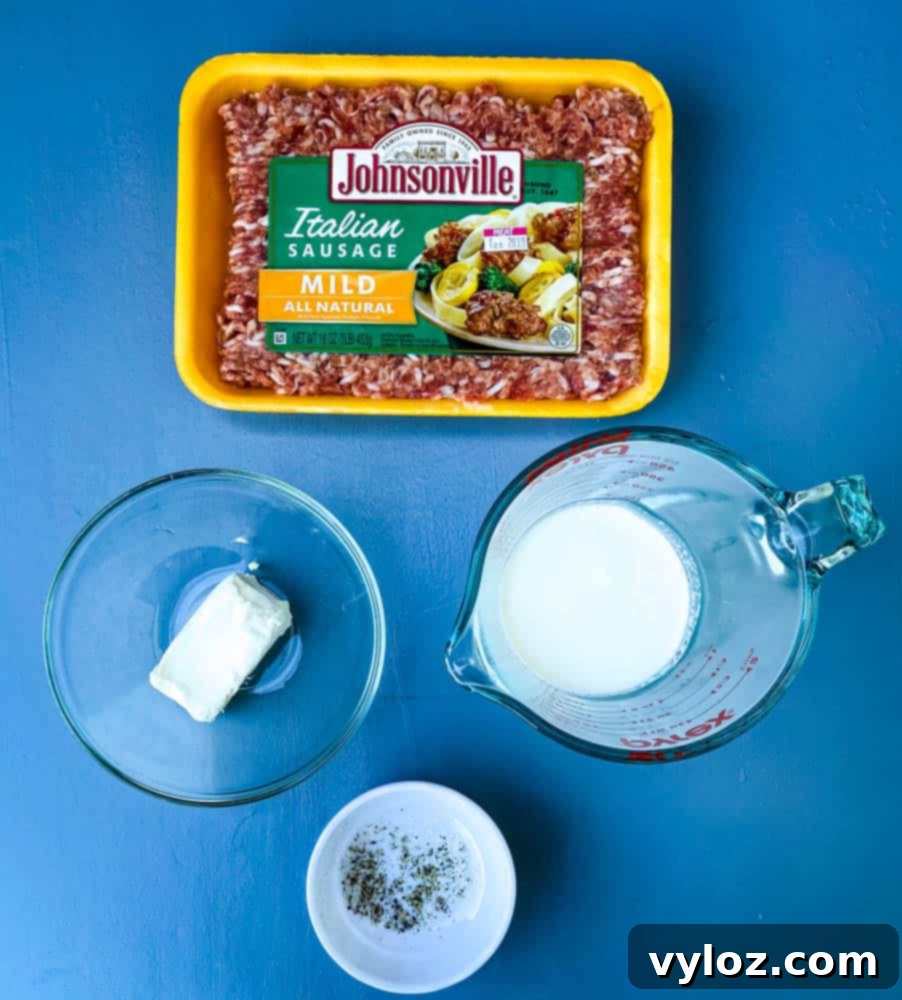 Essential ingredients for creamy keto sausage gravy: ground sausage, blocks of cream cheese, a jug of heavy cream, along with salt and pepper for seasoning.