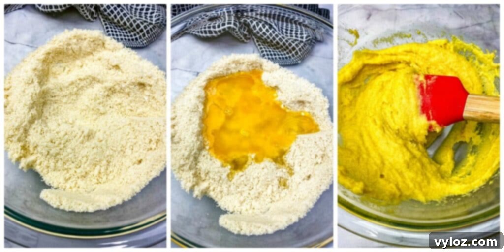 Close-up of fluffy keto low carb biscuit dough in a large white mixing bowl, perfectly mixed and ready for shaping.
