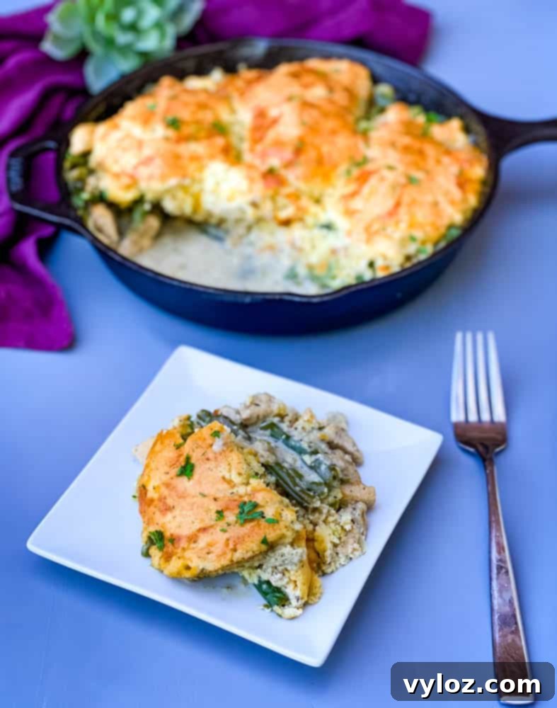 A slice of keto low carb chicken pot pie served next to the full pot pie in a cast iron skillet