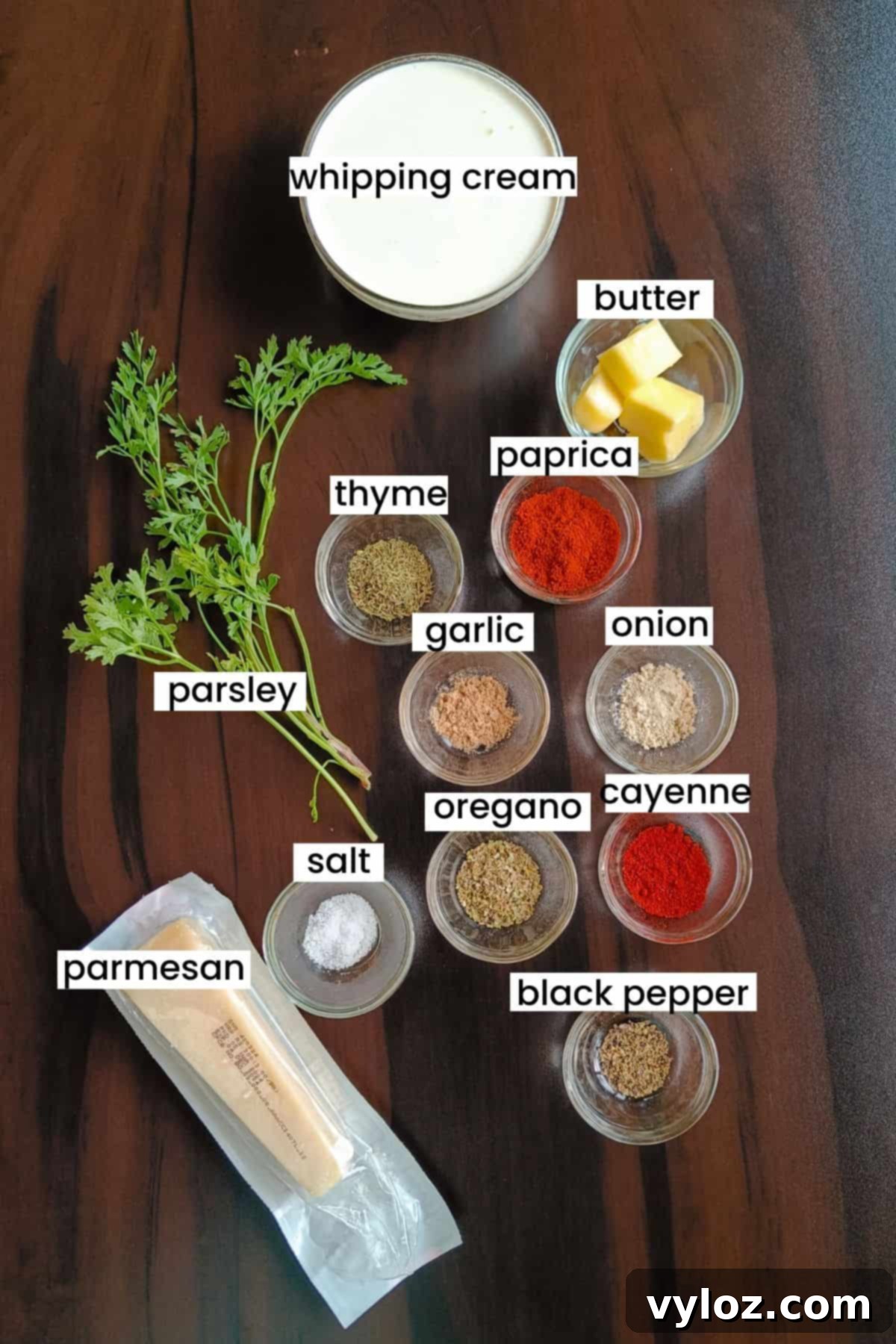 Image showing Cajun Alfredo sauce ingredients placed on a brown backdrop.