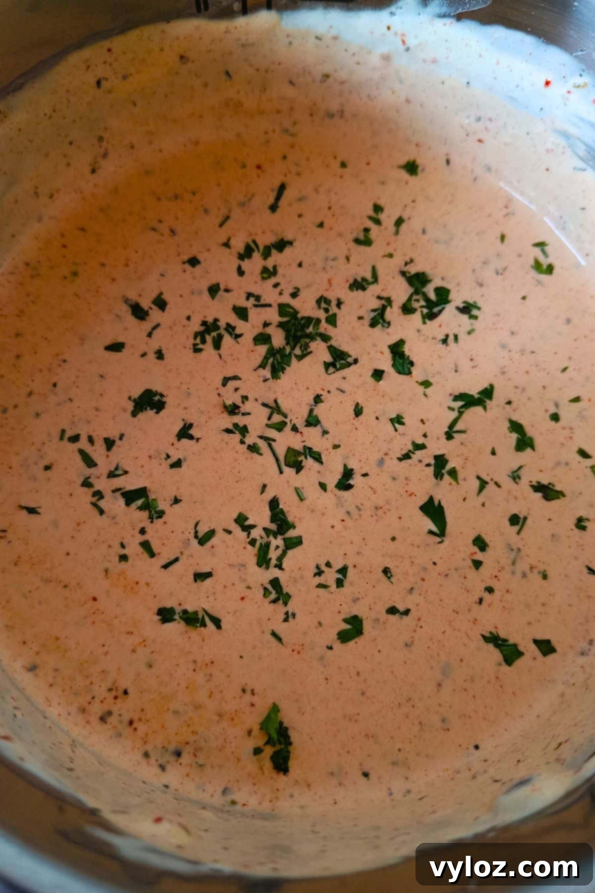 Image showing vibrant looking Cajun Alfredo sauce in a saucepan.