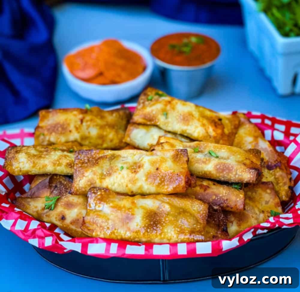 air fryer pizza rolls in a black bowl with pepperoni and marinara sauce