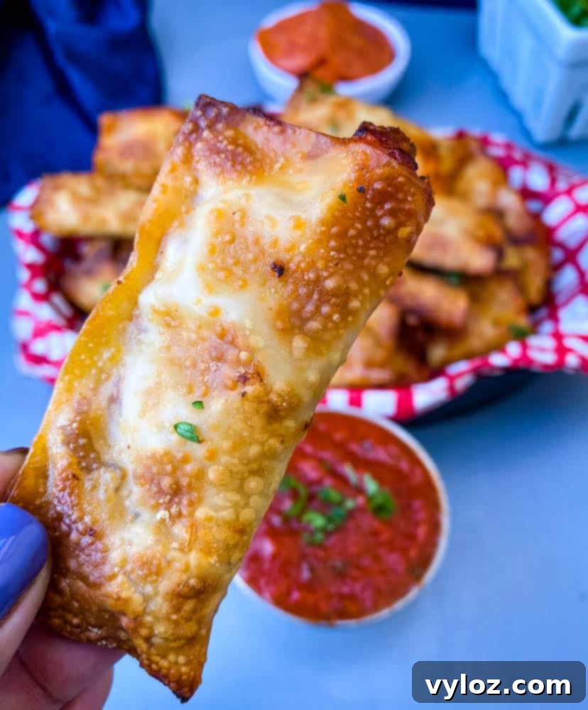 close up photo of person holding air fryer pizza roll