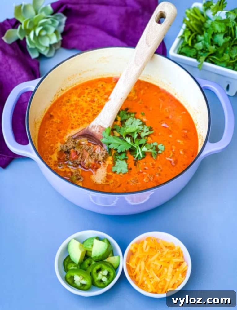 Keto low-carb taco soup simmering in a vibrant purple Dutch oven, ready to be served.