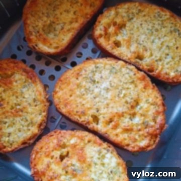 Crispy garlic bread toast prepared in an air fryer, ready to be served.