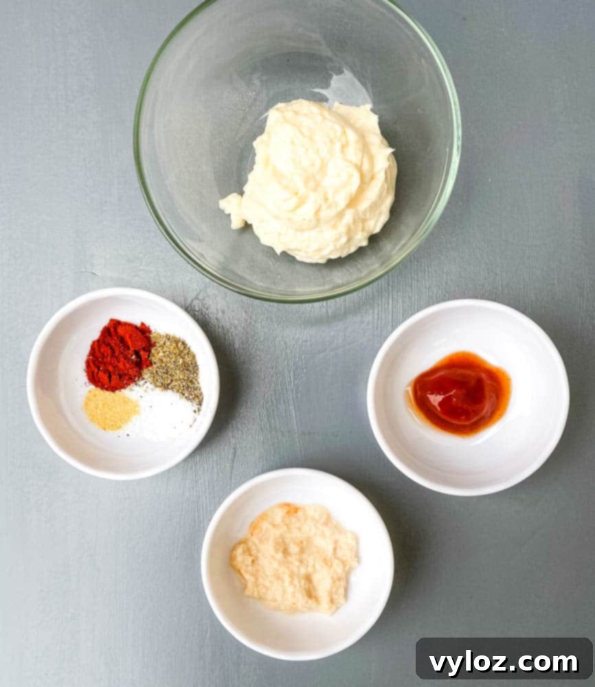 Restaurant-Style Air Fryer Blooming Onion 8 Mayonnaise, ketchup, horseradish, and various seasonings laid out to prepare the Air Fryer Blooming Onion dipping sauce.