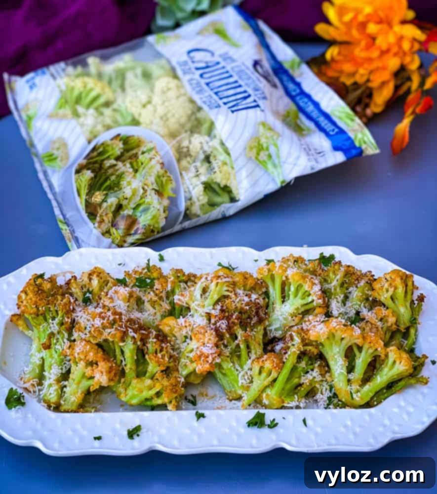 air fryer caulilini on a white plate, garnished with fresh herbs