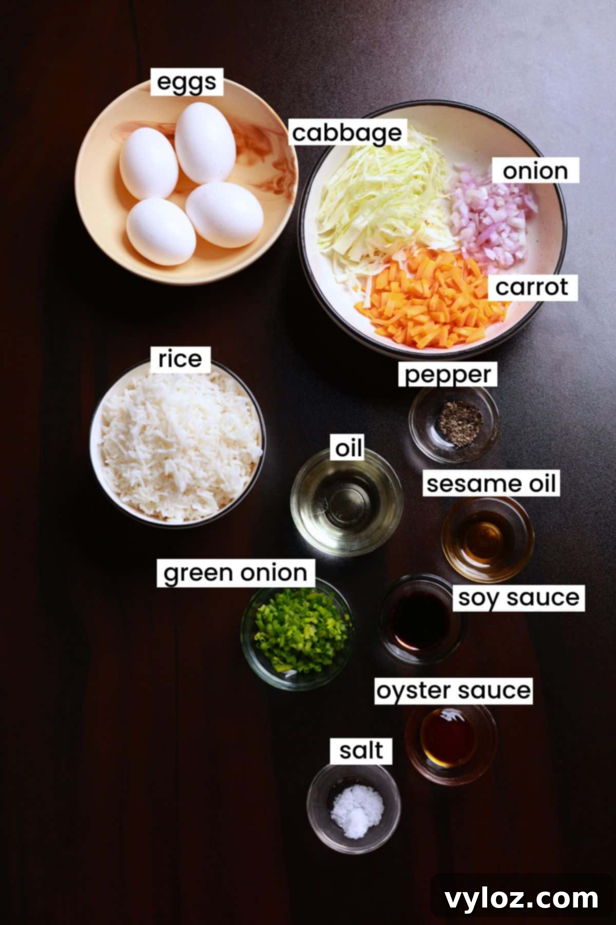 Image showing ingredients for fried rice are arranged on a brown background.