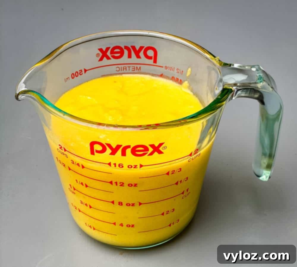 keto low carb cornbread mix batter in a glass mixing cup