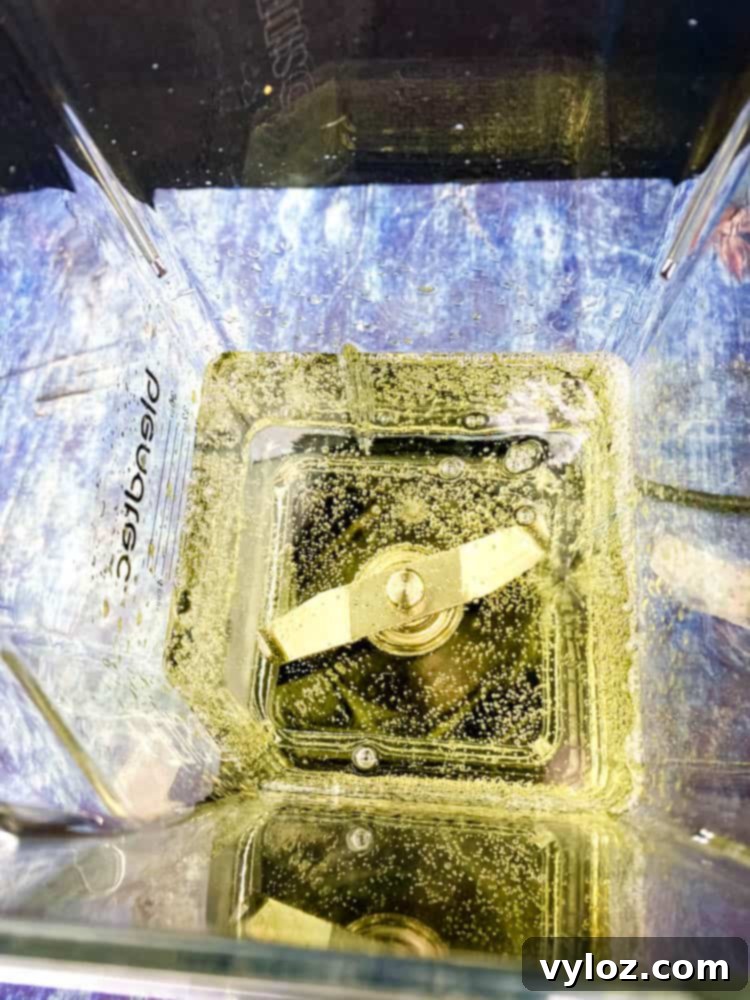 Effortless Peach Bellini Bliss 6 Prosecco sparkling wine being poured into a blender with frozen peaches to create a Peach Bellini puree.