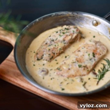 Creamy garlic chicken breasts topped with fresh herbs.