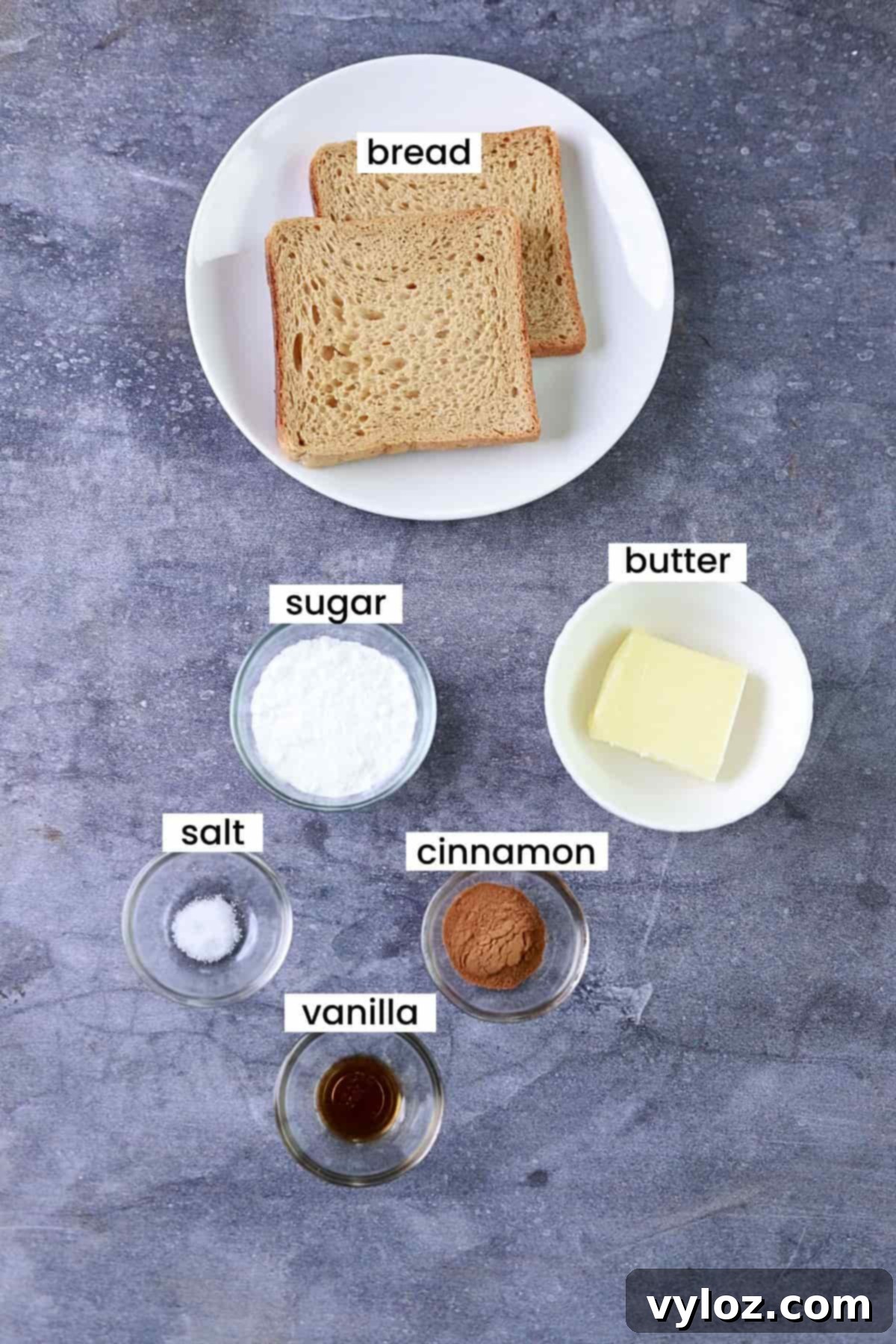 Golden Air Fryer Cinnamon Toast 3 Image showing cinnamon toast ingredients are placed on a grey backdrop.