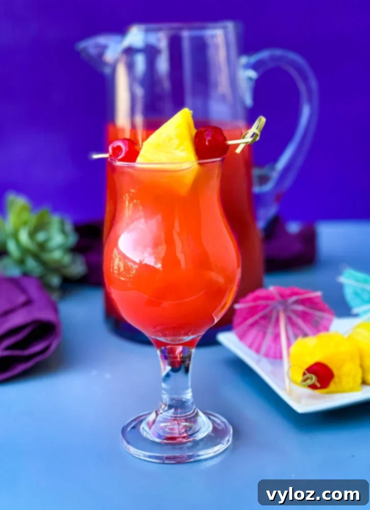 Bahama Mama Recipe in glasses with a pitcher of drink