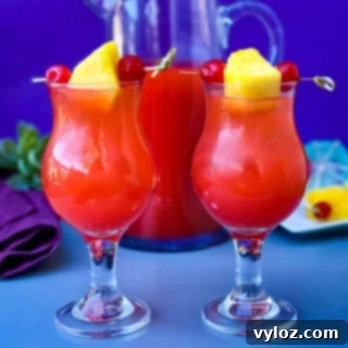 Bahama Mama Recipe in glasses with a pitcher of drink