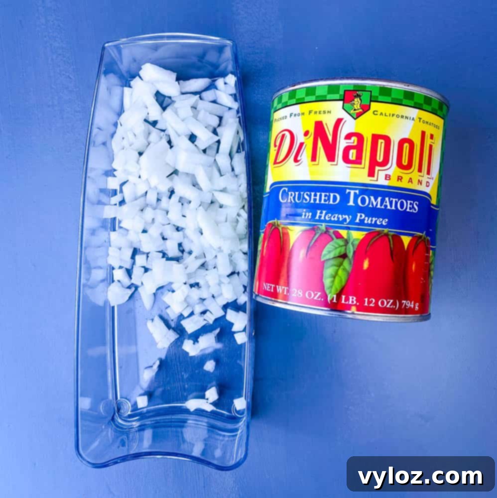 Freshly chopped onions and rich crushed tomatoes, essential ingredients for a flavorful keto low carb marinara sauce.