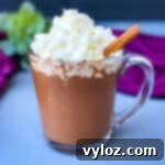 keto low carb hot chocolate in a glass mug with whipped cream and cinnamon
