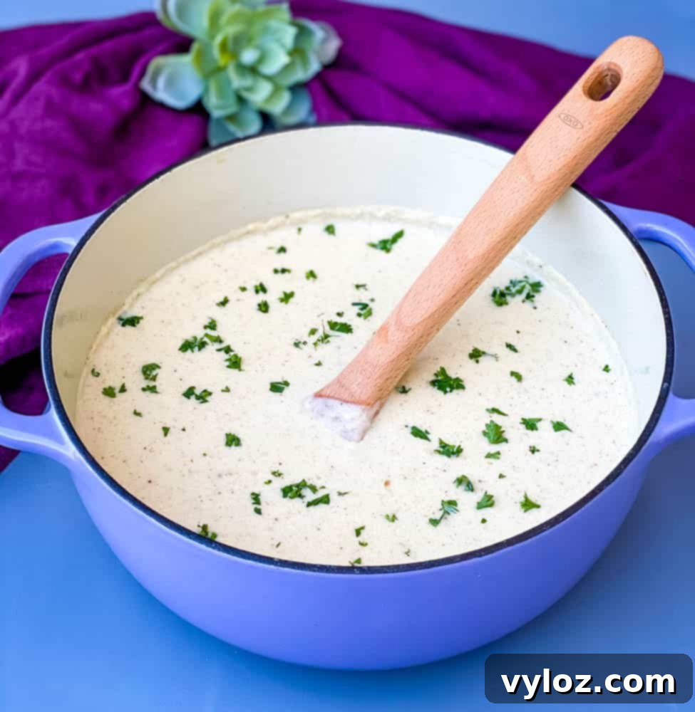 keto low carb roasted cauliflower soup in a purple Dutch oven