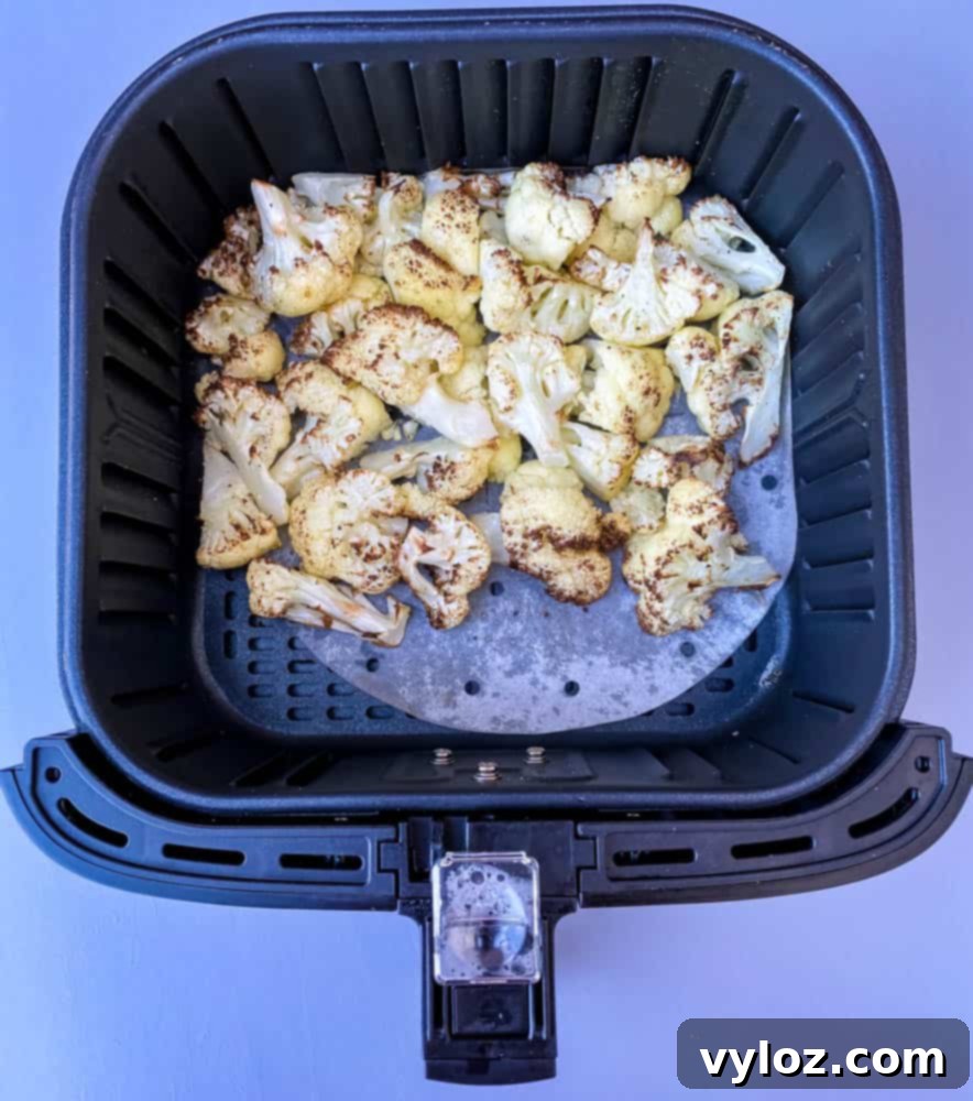 roasted cauliflower in an air fryer basket