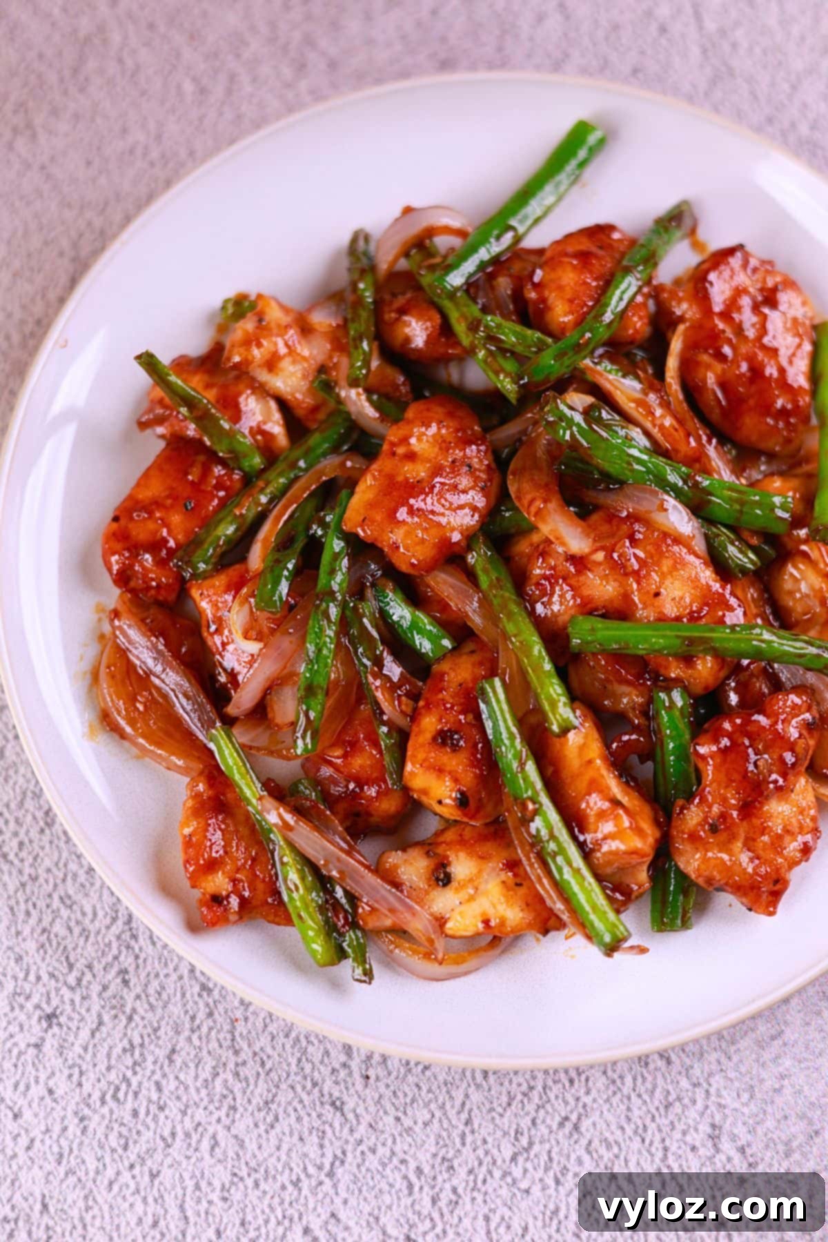 Effortless Chicken and Green Bean Stir Fry 6 Chicken and green bean stir fry served on a white plate, ready to enjoy.