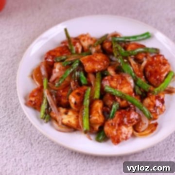Effortless Chicken and Green Bean Stir Fry 7 Close-up of juicy chicken and crisp green beans coated in stir fry sauce.